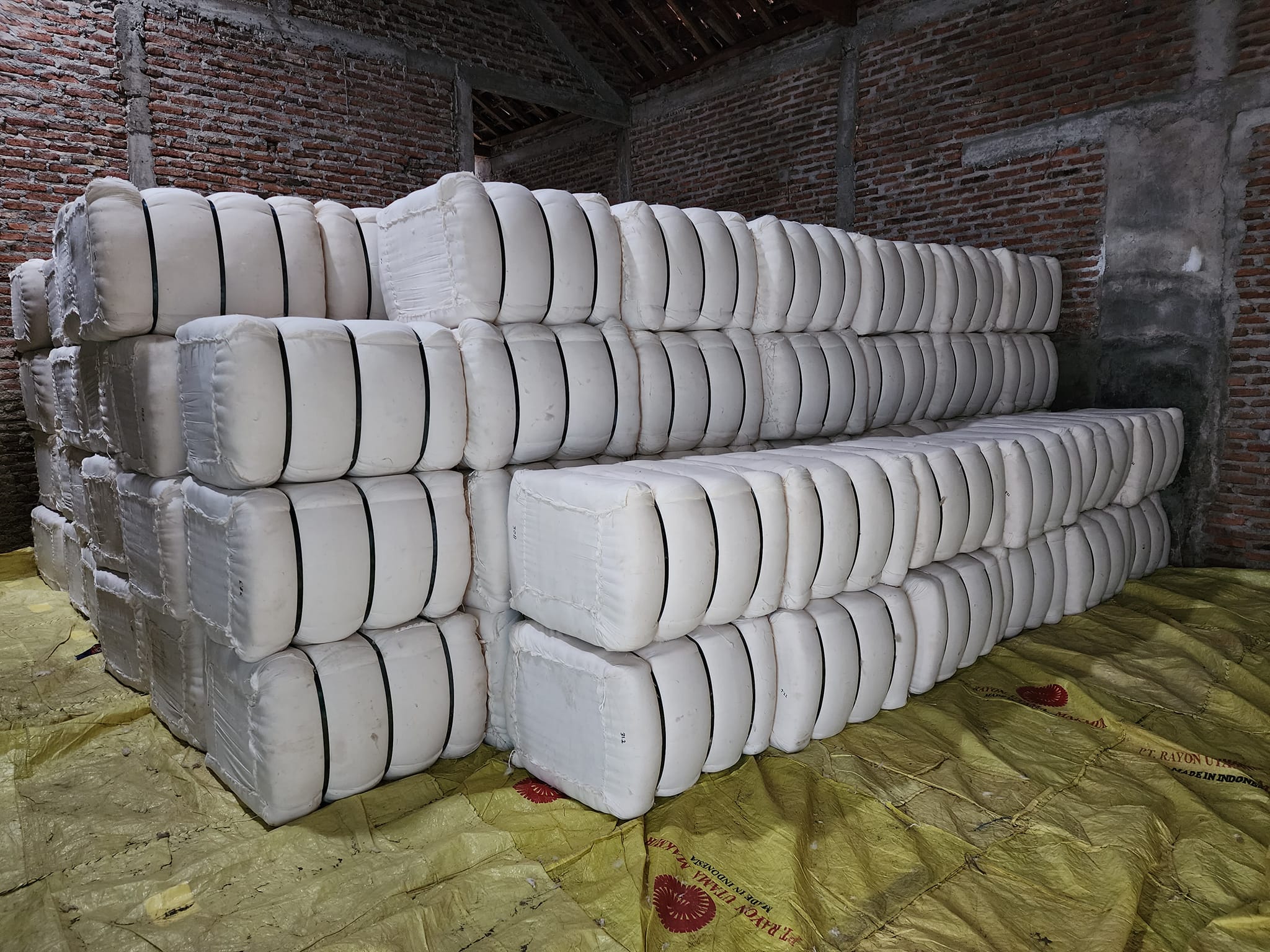 Compressed kapok fiber bales packed for international export from Loop Farms, Java Indonesia